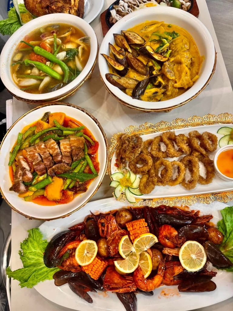 BASCO’s spread of Filipino dishes, golden crispy rings and a seafood platter with shrimp and mussels